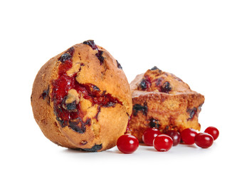 Sweet tasty muffins with cranberry on white background