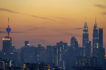 Fototapeta na wymiar Majestic sunset over Twin Towers and surrounded buildings in downtown Kuala Lumpur, Malaysia. 