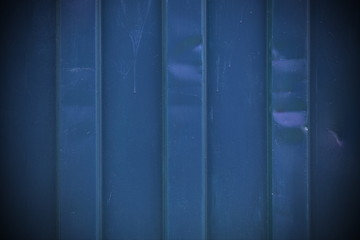 Dark blue vignetted shipping container background texture