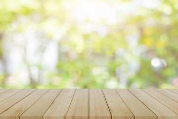 Empty wooden desk of free space and spring time with blurred background of home garden for a catering or food background,Template mock up for display montages of product.