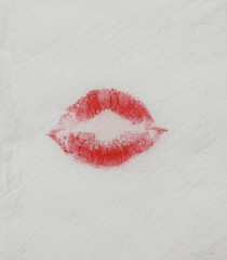Woman to use red lipstick and kiss on the tissue paper background.