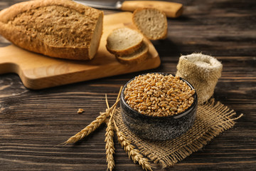 Composition with raw wheat on wooden table