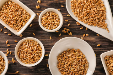 Composition with raw wheat on wooden table