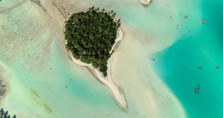 small islands (motu) in the middle of a lagoon in aerial view, French Polynesia