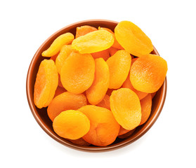 Fototapeta na wymiar Bowl with dried apricots on white background