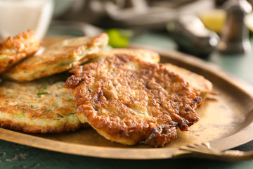 Zucchini pancakes on metal tray, closeup