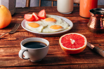 Breakfast with coffee and fried eggs