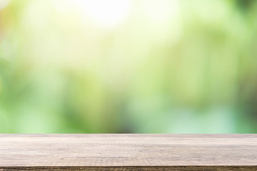 Empty wooden desk of free space and spring time with blurred background of home garden for a catering or food background,Template mock up for display montages of product.