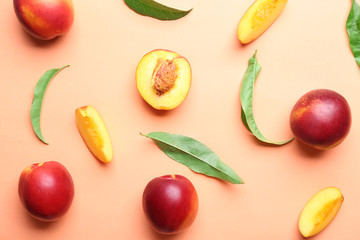 Composition with ripe peaches on color background, top view