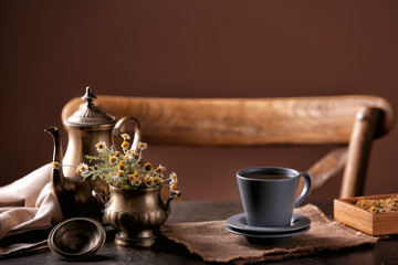 Cup of delicious chamomile tea on table