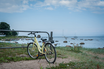 Fototapeta premium Bicycle parked along the stoned coast of Baltic sea. Kasmu, village of captains, Estonia. Copy space.