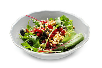 Bowl with healthy fresh salad on white background