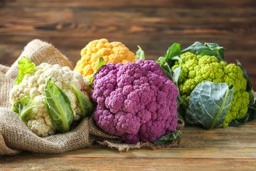 Colorful cauliflowers on wooden table