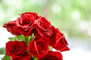 Beautiful bouquet of red roses on blurred background, closeup