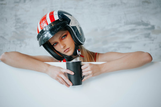 Female biker girl with black full face motorcycle helmet. Copy space for advertising biker products. Extreme lifestyle concept.