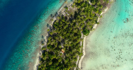 small islands (motu) in the middle of a lagoon in aerial view, French Polynesia