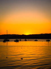 Fototapeta na wymiar Boats and sunset colors in Santo Antonio de Lisboa, fishermen village in Florianopolis - Brazil