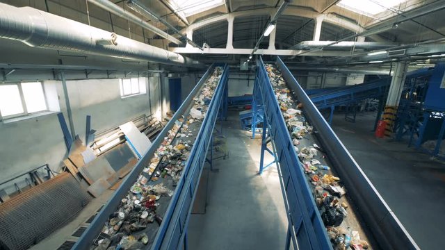 Rubbish recycling plant with two functioning conveyor belts.
