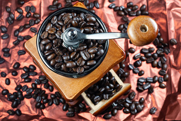 Fototapeta na wymiar Coffee beans and vintage wooden grinder.