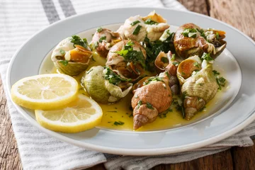 Papier Peint photo Lavable Crustacés Bulots Cuits - Cooked Waved Whelks with a sauce of butter, garlic and parsley, lemon close-up. Horizontal