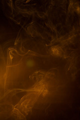 Gold smoke on black background.