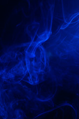 Blue smoke on black background.