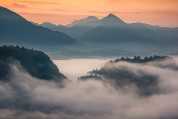 Sunrise over the Alps mountains at foggy morning in Bled, Slovenia