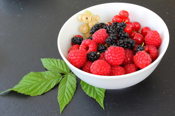 fresh fruits in a small white bowl