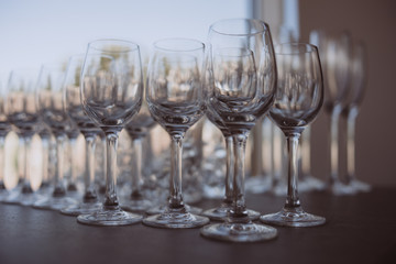 Crystal clear empty wine glasses on the table. Alcohol background. 