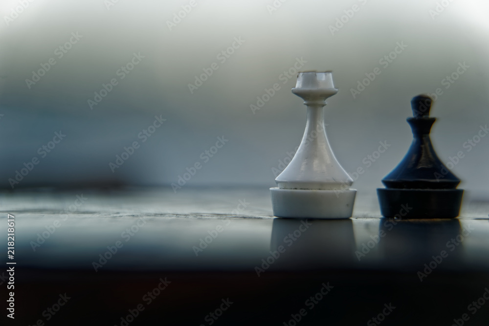 Wall mural Macro chess piece - rook and pawn with defocused background