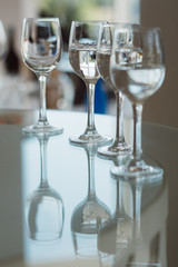 Crystal   wine glasses with alcoholic beverage on the table. 