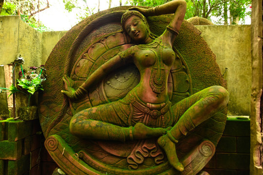 Statue of Goddess naked chest There are green moss on the body. 	