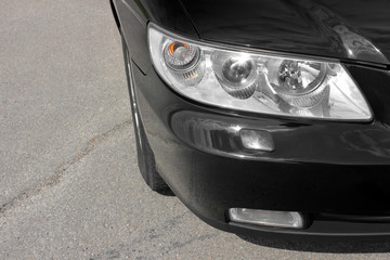 Car headlights. Front of the black car.