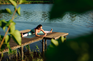 Healthy woman lifestyle balanced practicing meditate and energy yoga on the bridge in morning the nature. Healthy Concept.