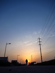 Fototapeta na wymiar A cyclist riding in the sunset