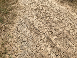 yellow crack dry dirt background texture and tire