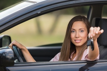 Portrait of a Smiling Woman Looking out of the Window of her Car