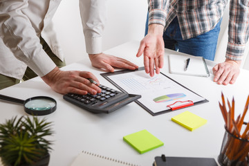 Business concept. Two business mans working and meeting with chart at office on his desk.