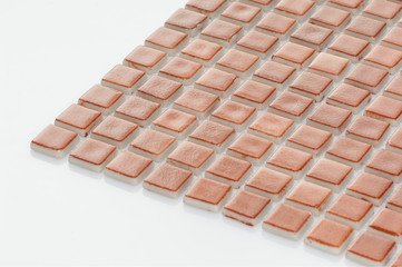 little brown ceramic tile on a white background, majolica. for the catalog