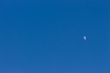 Paraglider isolated in blue sky