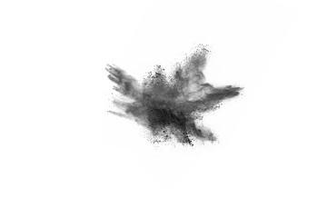 Black powder explosion. Closeup of black dust particles explode isolated on white background.