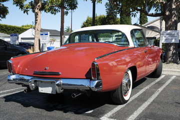 A view of a classic vintage American car in a parking lot