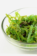 wakame salad with sesame in a small glass bowl isolated