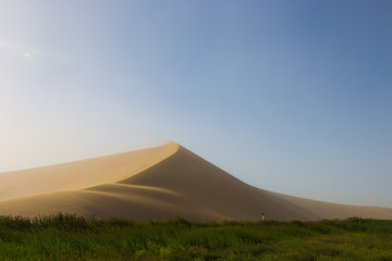 Fototapeta na wymiar Empty Desert in Sand storm over blue sky summer