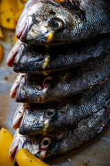 Fish Sparus aurata for baking with potatoes and greens