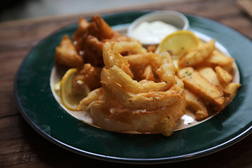 Fish and chips fried fish and potatoes on wood background vintage style