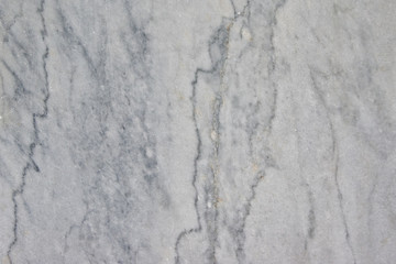 Fototapeta premium smooth stone surface with a crack, grey marble close-up for background