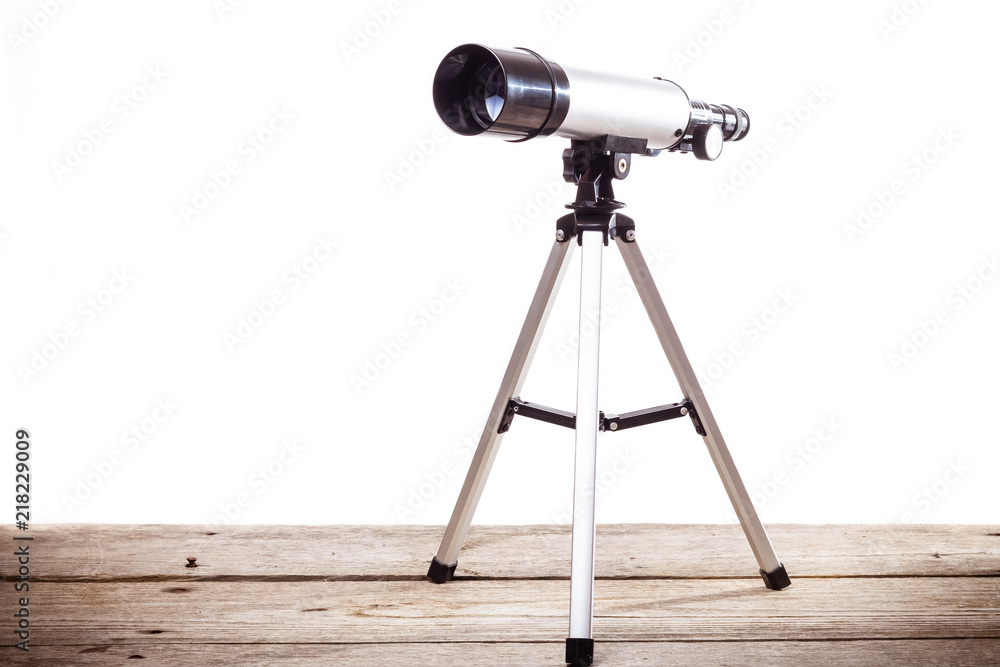Wall mural telescope on a white background laid on wooden board
