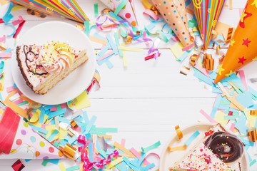Fototapeta na wymiar birthday cake and decoration on white wooden background