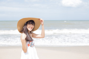 Fototapeta na wymiar Beautiful girl enjoy and happy on the beach, Hua Hin, Thailand